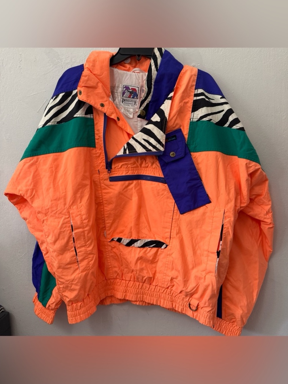 Peregrine Orange windbreaker jacket with zebra print details #windbreakerUnisex
